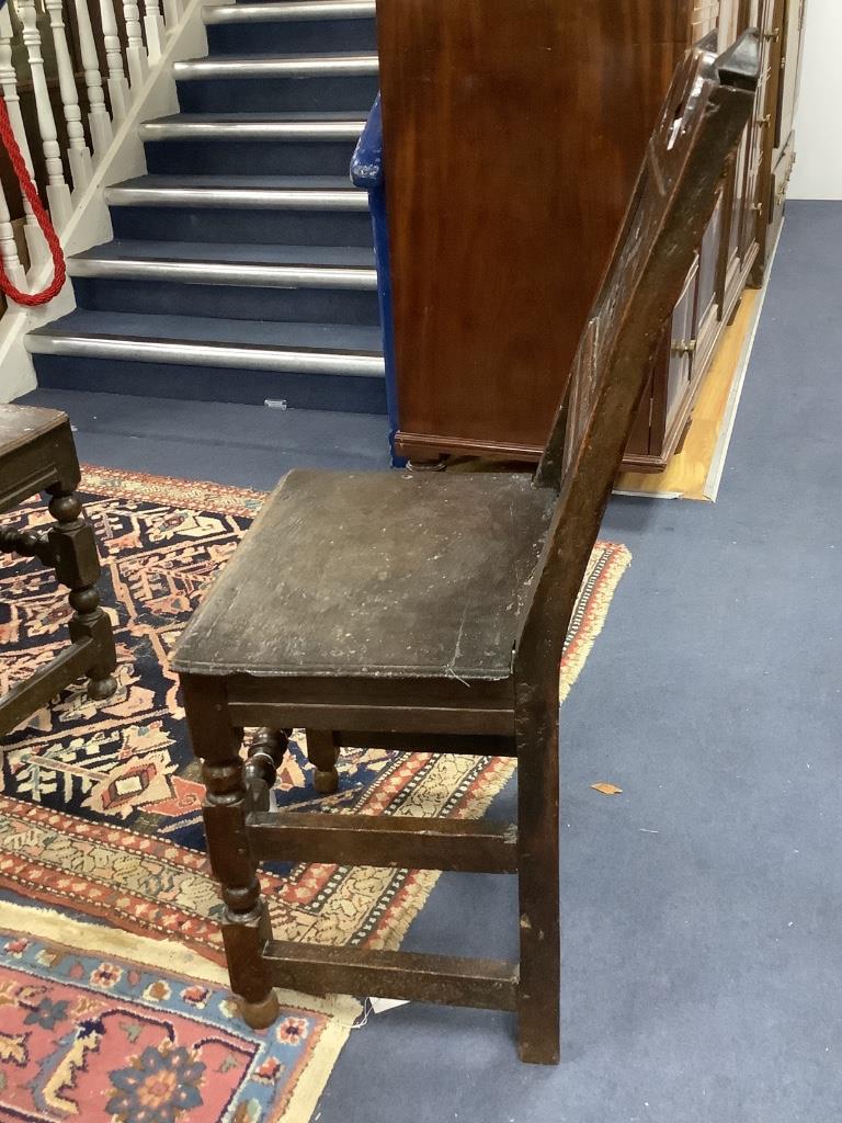 An 17th century oak back stool with lozenge carved decoration, width 48cm, depth 38cm, height 96cm